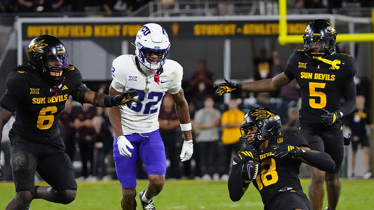 TCU wide receiver Dozie Ezukanma looks back as Arizona State defenders converge after an interception.