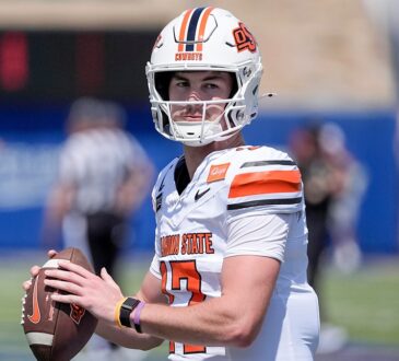 Oklahoma State quarterback Drew Mestemaker, No. 17, holds the ball at chest level during pregame warmups.