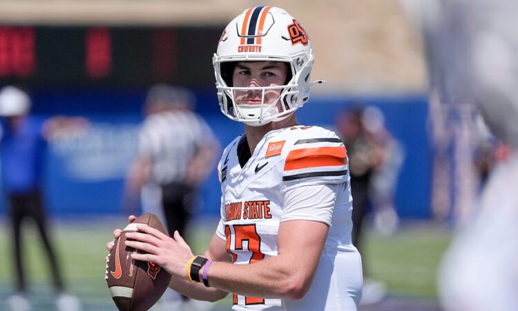 Oklahoma State quarterback Drew Mestemaker, No. 17, holds the ball at chest level during pregame warmups.