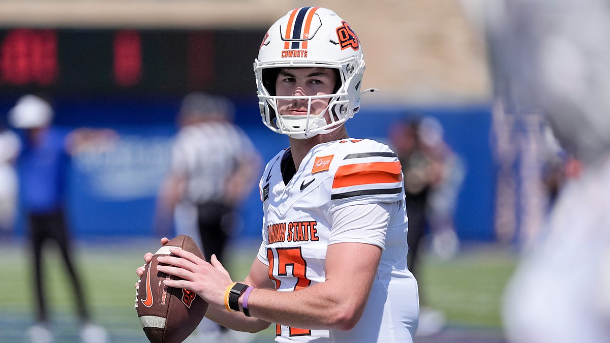 Oklahoma State quarterback Drew Mestemaker, No. 17, holds the ball at chest level during pregame warmups.