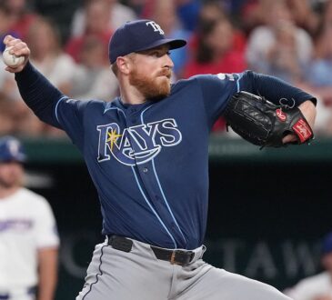 Tampa Bay Rays starting pitcher Drew Rasmussen, No. 57, comes set to deliver a pitch.