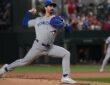 Toronto Blue Jays pitcher Dylan Cease strides toward the plate mid-delivery against Texas at Globe Life Field.