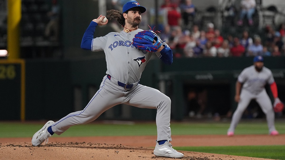 Toronto Blue Jays pitcher Dylan Cease strides toward the plate mid-delivery against Texas at Globe Life Field.