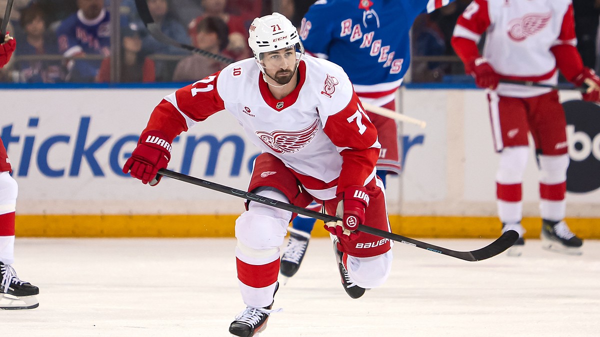 Detroit Red Wings center Dylan Larkin skates up ice with his stick extended during a game against the Rangers.
