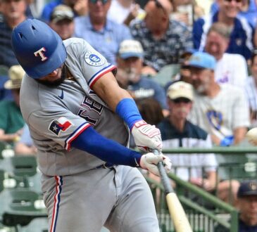 Texas Rangers catcher Elias Díaz drives a pitch with the ball visible off the barrel.