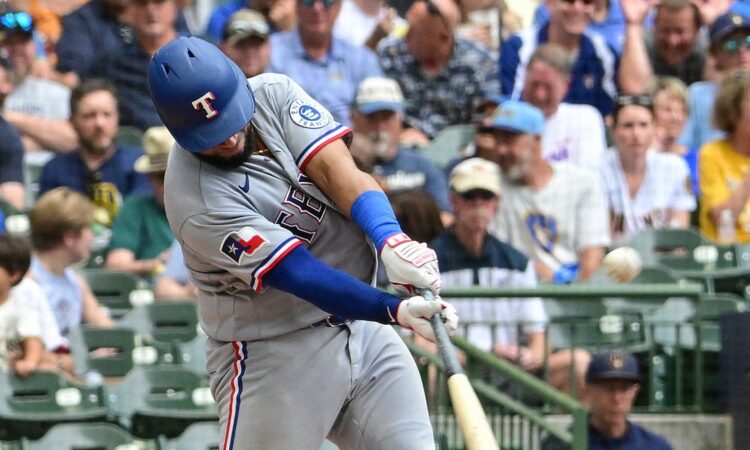 Texas Rangers catcher Elias Díaz drives a pitch with the ball visible off the barrel.