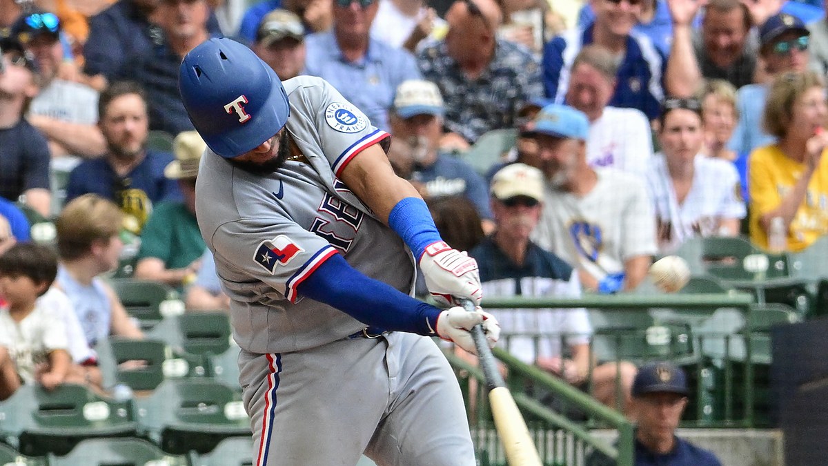 Texas Rangers catcher Elias Díaz drives a pitch with the ball visible off the barrel.