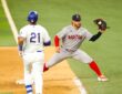 Red Sox first baseman Willson Contreras stretches to take the throw as Elias Díaz reaches the bag.