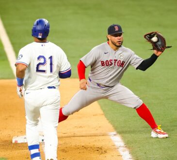 Red Sox first baseman Willson Contreras stretches to take the throw as Elias Díaz reaches the bag.