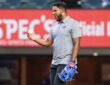Former Texas Rangers shortstop Elvis Andrus smiles while holding a baseball and wearing a blue glove on the field.