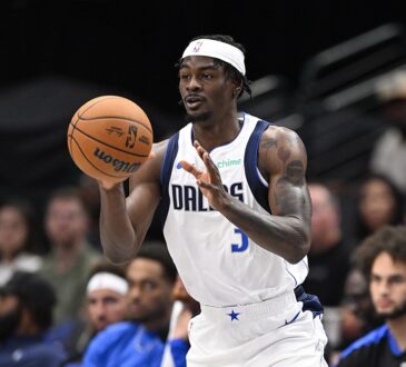 Dallas Mavericks forward Emanuel Miller catches a pass in front of the Dallas bench.