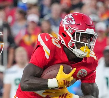 Kansas City Chiefs running back Emari Demercado tucks the ball and turns upfield at Arrowhead Stadium.
