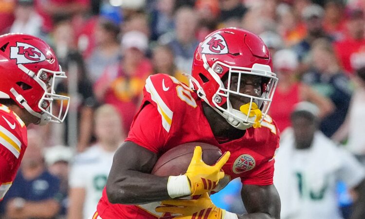Kansas City Chiefs running back Emari Demercado tucks the ball and turns upfield at Arrowhead Stadium.