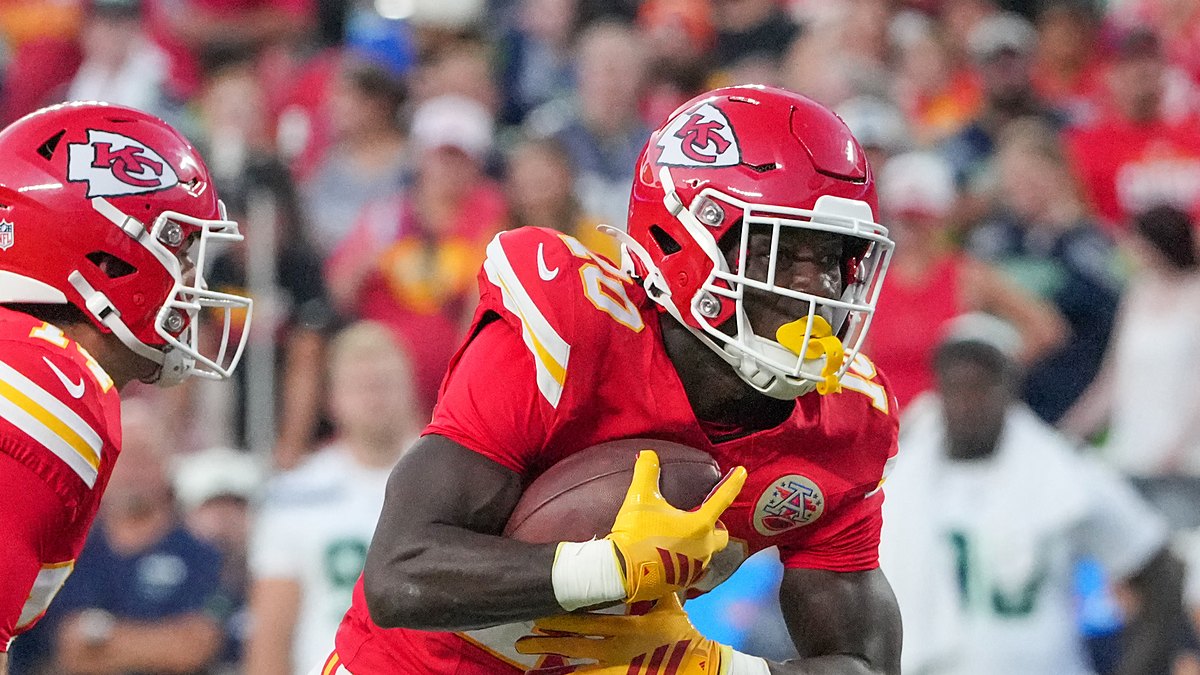 Kansas City Chiefs running back Emari Demercado tucks the ball and turns upfield at Arrowhead Stadium.