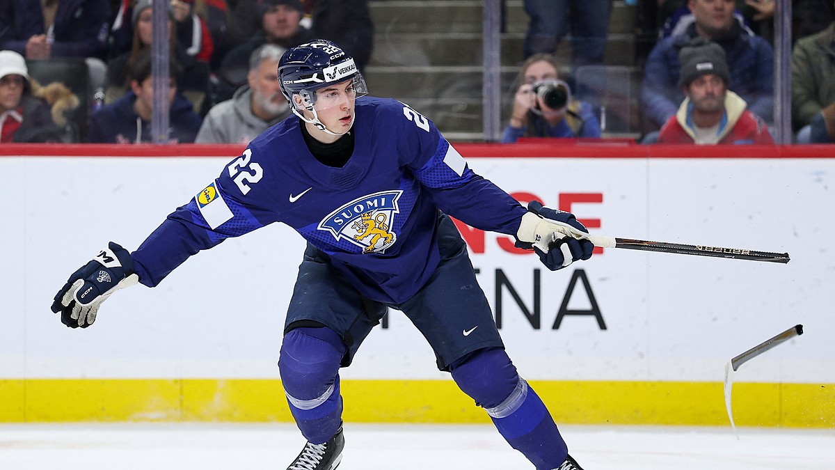 Finland forward Emil Hemming, No. 22, follows through with a broken stick after a shot as the blade skids away.