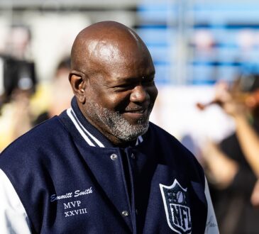 Former Dallas Cowboys running back Emmitt Smith wears his Super Bowl MVP jacket on the field before the game.