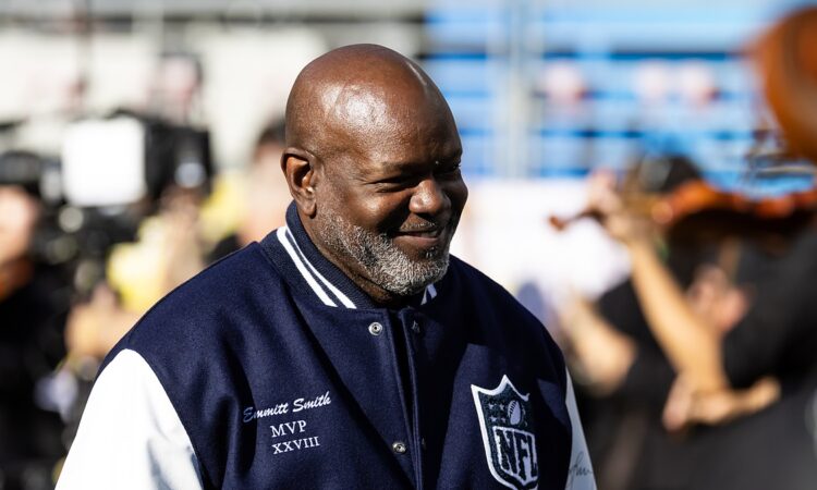 Former Dallas Cowboys running back Emmitt Smith wears his Super Bowl MVP jacket on the field before the game.
