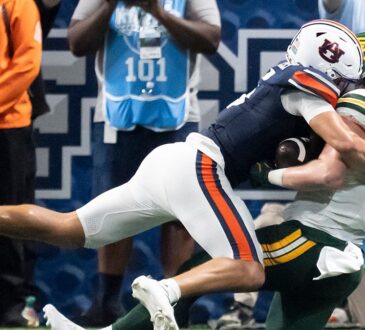 Auburn safety Eric Winters, No. 5, tackles Baylor tight end Matthew Klopfenstein short of the goal line.