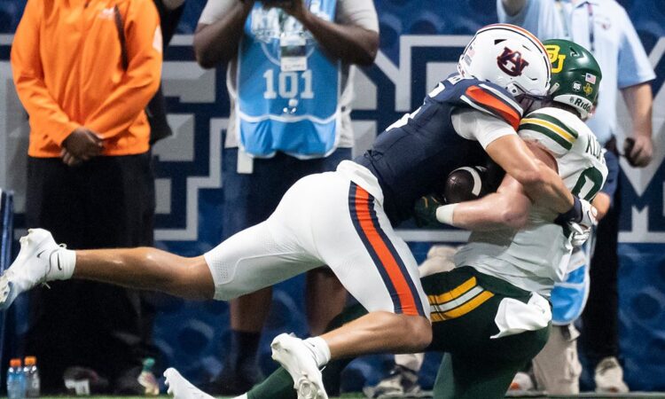 Auburn safety Eric Winters, No. 5, tackles Baylor tight end Matthew Klopfenstein short of the goal line.