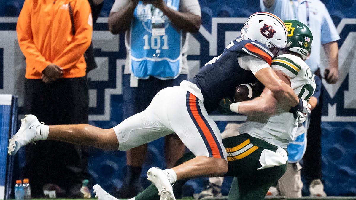 Auburn safety Eric Winters, No. 5, tackles Baylor tight end Matthew Klopfenstein short of the goal line.
