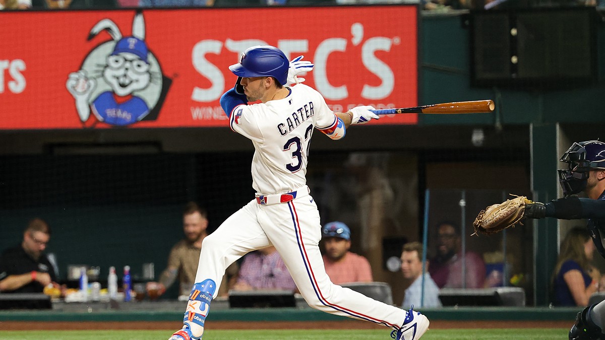 Texas Rangers center fielder Evan Carter, No. 32, follows through on a swing at Globe Life Field.