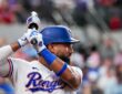 Texas Rangers shortstop Ezequiel Durán holds his bat while waiting on deck at Globe Life Field.