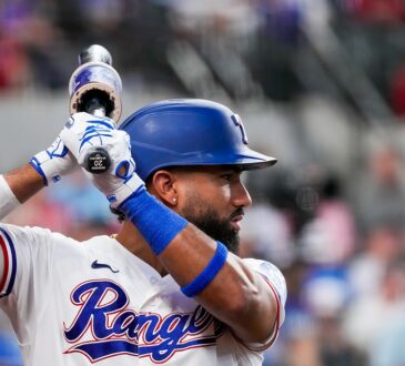 Texas Rangers shortstop Ezequiel Durán holds his bat while waiting on deck at Globe Life Field.