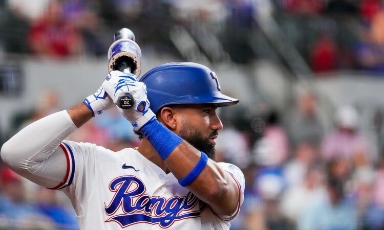 Texas Rangers shortstop Ezequiel Durán holds his bat while waiting on deck at Globe Life Field.