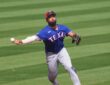 Texas Rangers infielder Ezequiel Durán, No. 20, fires a sidearm throw to first base on the run.