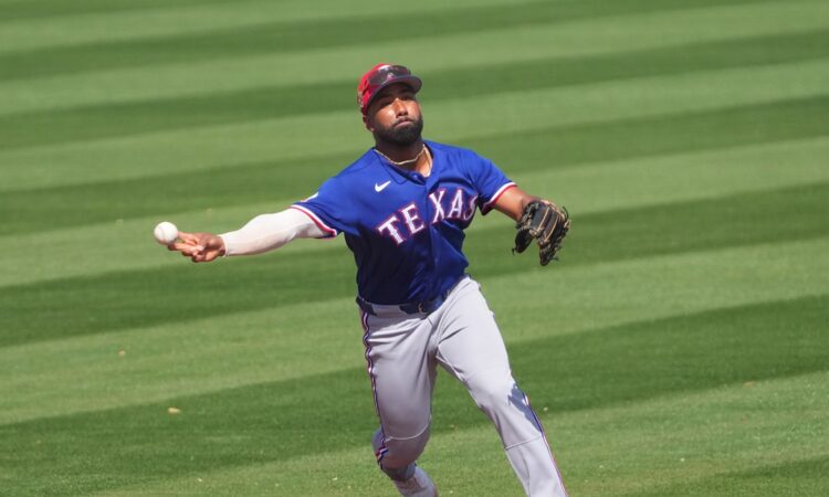 Texas Rangers infielder Ezequiel Durán, No. 20, fires a sidearm throw to first base on the run.