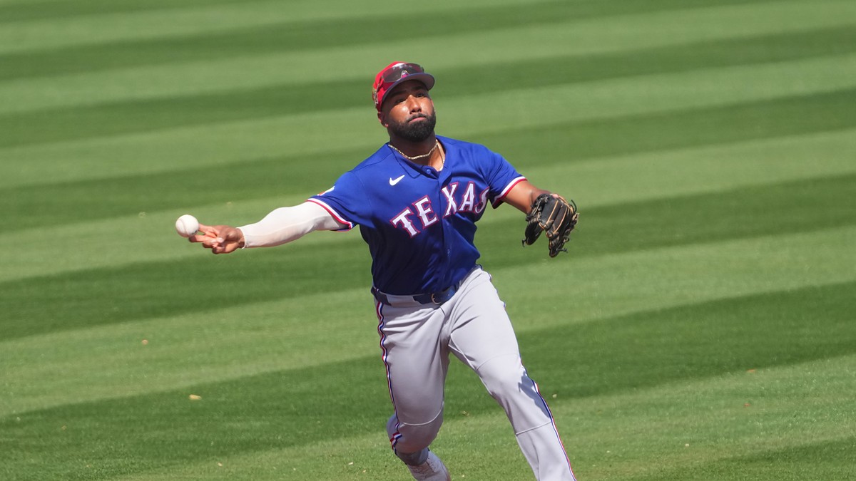 Texas Rangers infielder Ezequiel Durán, No. 20, fires a sidearm throw to first base on the run.