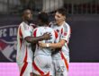 FC Dallas players Shaq Moore, Kaick Ferreira, and Logan Farrington embrace after a goal at Toyota Stadium.