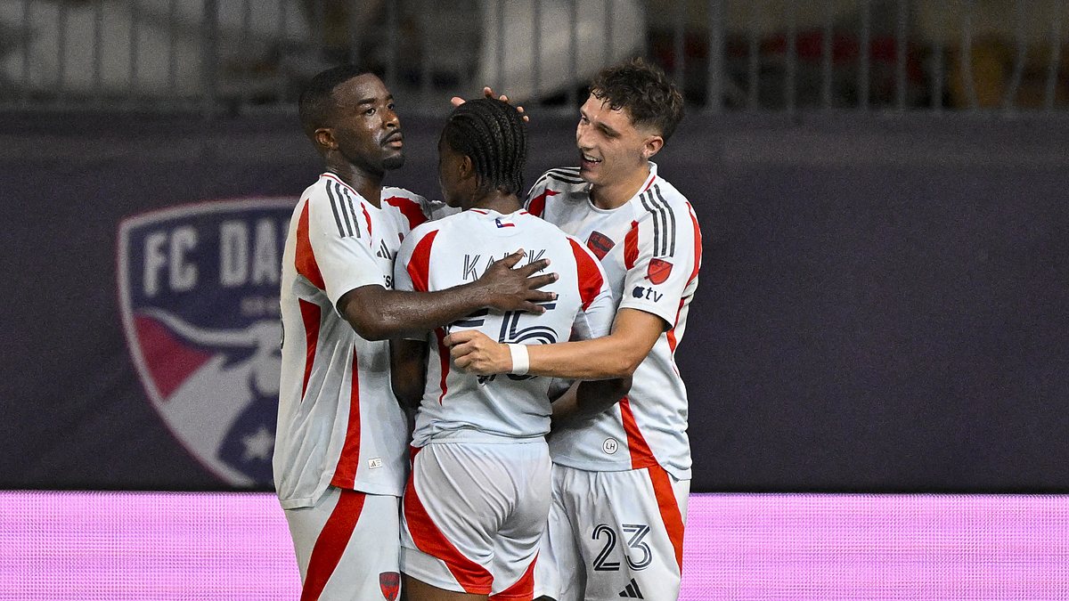FC Dallas players Shaq Moore, Kaick Ferreira, and Logan Farrington embrace after a goal at Toyota Stadium.