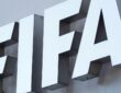 The white FIFA logo mounted on the gray exterior wall of the organization’s headquarters.
