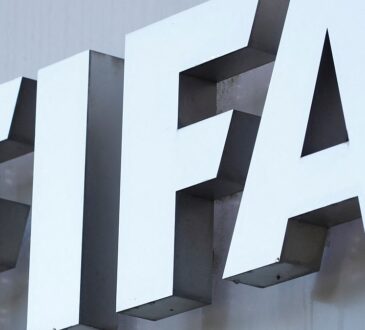 The white FIFA logo mounted on the gray exterior wall of the organization’s headquarters.