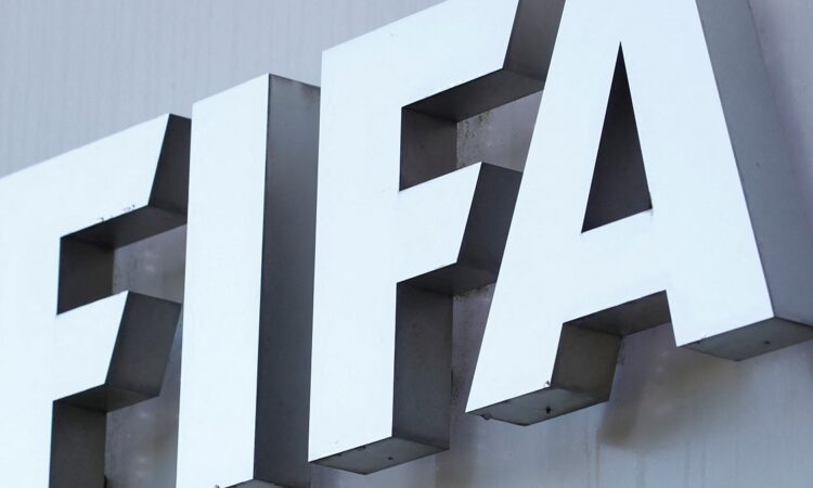 The white FIFA logo mounted on the gray exterior wall of the organization’s headquarters.