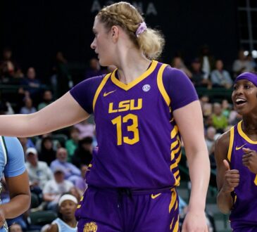 LSU Tigers guard Flau’jae Johnson, right, reacts as teammate Kate Koval points downcourt beside a Tulane defender.
