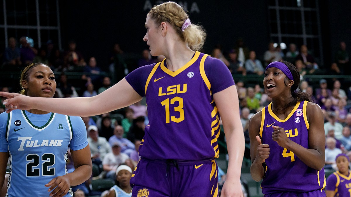 LSU Tigers guard Flau’jae Johnson, right, reacts as teammate Kate Koval points downcourt beside a Tulane defender.