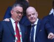 Royal Moroccan Football Federation president Fouzi Lekjaa stands with FIFA president Gianni Infantino in the stands before a match.