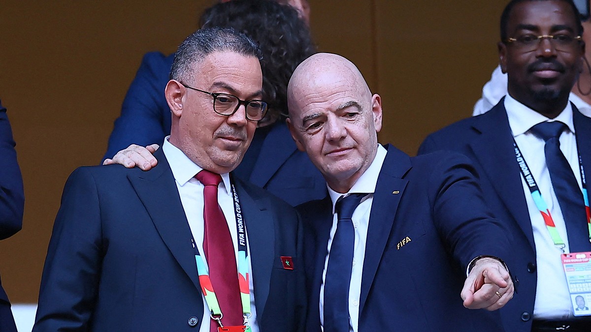 Royal Moroccan Football Federation president Fouzi Lekjaa stands with FIFA president Gianni Infantino in the stands before a match.