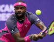 Frances Tiafoe tracks the ball into a two-handed backhand during a match.