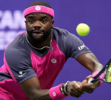 Frances Tiafoe tracks the ball into a two-handed backhand during a match.