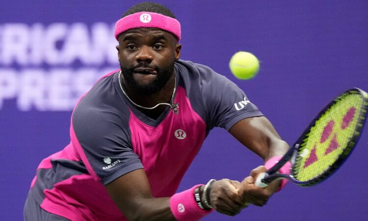 Frances Tiafoe tracks the ball into a two-handed backhand during a match.