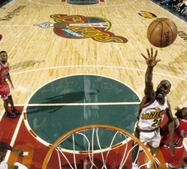 Seattle SuperSonics guard Gary Payton #20 lays the ball up against Michael Jordan and the Chicago Bulls during the 1996 NBA Finals at KeyArena.