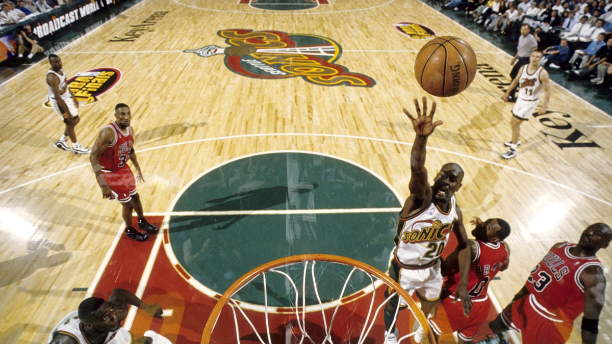 Seattle SuperSonics guard Gary Payton #20 lays the ball up against Michael Jordan and the Chicago Bulls during the 1996 NBA Finals at KeyArena.