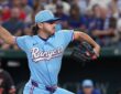 Texas Rangers pitcher Gavin Collyer winds up to throw in a powder blue Rangers uniform.