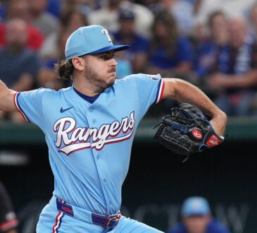Texas Rangers pitcher Gavin Collyer winds up to throw in a powder blue Rangers uniform.