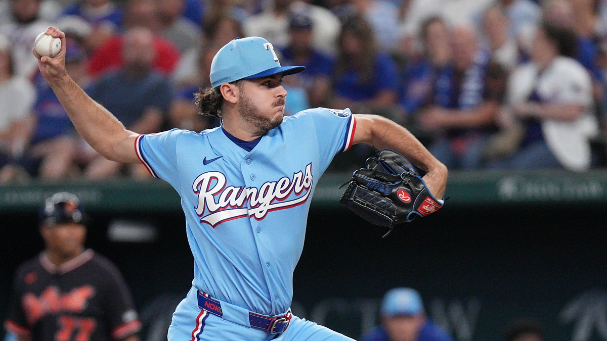 Texas Rangers pitcher Gavin Collyer winds up to throw in a powder blue Rangers uniform.
