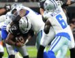 Las Vegas Raiders quarterback Geno Smith, No. 7, is wrapped up by two Dallas Cowboys defensive tackles.