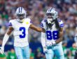 Dallas Cowboys wide receiver George Pickens puts a hand on the back of teammate CeeDee Lamb, who yells and clenches his fists.